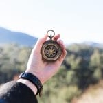 hand holding a compass